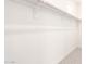 Empty walk-in closet features neutral carpet and wooden bars for hanging clothes at 13660 N 144Th Ln, Surprise, AZ 85379