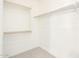 A simple walk-in closet with wooden bars for hanging clothes at 13660 N 144Th Ln, Surprise, AZ 85379