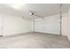 Spacious two car garage with door and mechanical opener and concrete floor at 13660 N 144Th Ln, Surprise, AZ 85379