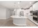 Modern kitchen with a large island, stainless steel appliances, and stylish pendant lighting at 13660 N 144Th Ln, Surprise, AZ 85379