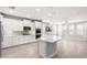 Bright kitchen with white cabinetry, stainless appliances, and a large island with pendant lighting at 13660 N 144Th Ln, Surprise, AZ 85379