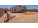 Large backyard offers rock landscaping, block wall, brick patio, and covered patio at 1374 E Linda Dr, Casa Grande, AZ 85122
