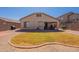 Great view of the backyard which features an outdoor covered patio, small lawn, and rock landscaping at 1374 E Linda Dr, Casa Grande, AZ 85122