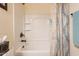 Bathroom features a well lit shower and bath combination with a decorative curtain and hardware at 1374 E Linda Dr, Casa Grande, AZ 85122