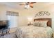 Comfortable bedroom features a ceiling fan and patterned bedding creating a relaxing space at 1374 E Linda Dr, Casa Grande, AZ 85122