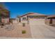 Charming single-story home featuring a tile roof, desert landscaping, and two-car garage at 1374 E Linda Dr, Casa Grande, AZ 85122