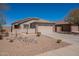 Charming single-story home featuring a tile roof, desert landscaping, and two-car garage at 1374 E Linda Dr, Casa Grande, AZ 85122