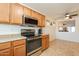 Stylish kitchen featuring stainless steel appliances, and passthrough to the dining room at 1374 E Linda Dr, Casa Grande, AZ 85122