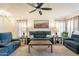 Comfortable living room with a ceiling fan, plush seating, and natural light at 1374 E Linda Dr, Casa Grande, AZ 85122