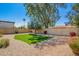 Landscaped backyard featuring artificial turf, stone ground cover, mature trees, and block wall at 14432 N 39Th Way, Phoenix, AZ 85032