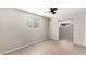 Bedroom with tile floor, ceiling fan, window, and view to the next room at 14432 N 39Th Way, Phoenix, AZ 85032