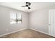 Bedroom with ceiling fan, wood floor, and window providing natural light at 14432 N 39Th Way, Phoenix, AZ 85032