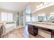 Bright and airy main bathroom with dual vanities, granite countertops, a soaking tub, and a glass-enclosed shower at 14443 W Morning Star Trl, Surprise, AZ 85374