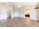 Expansive main bedroom with wood-look tile, vaulted ceiling, walk-in closet, and access to the ensuite bathroom at 14443 W Morning Star Trl, Surprise, AZ 85374