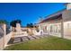 Beautiful backyard featuring an outdoor kitchen, a fireplace, and an outdoor dining area providing a space for outdoor enjoyment at 15021 N 19Th Way, Phoenix, AZ 85022