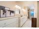 Bright bathroom with dual sinks, decorative mirrors, and walk-in shower at 15021 N 19Th Way, Phoenix, AZ 85022