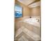 Relaxing bathroom featuring a deep soaking tub under a bright skylight at 15021 N 19Th Way, Phoenix, AZ 85022