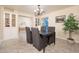 Formal dining room area featuring a modern chandelier, decorative tree, and elegant decor at 15021 N 19Th Way, Phoenix, AZ 85022