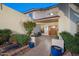 Enclosed front courtyard with pavers, flowering shrubbery, and custom tiled accents create a welcoming private entrance at 15021 N 19Th Way, Phoenix, AZ 85022
