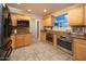 Bright kitchen features stainless steel appliances, granite counters, tile flooring, and custom wood cabinetry at 15021 N 19Th Way, Phoenix, AZ 85022