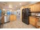 Spacious kitchen featuring stainless steel appliances, wood cabinetry, and an adjoining breakfast nook at 15021 N 19Th Way, Phoenix, AZ 85022
