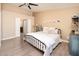 Light-filled main bedroom boasts neutral walls, a modern ceiling fan, and hardwood flooring at 15021 N 19Th Way, Phoenix, AZ 85022