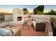 Outdoor patio with white fireplace, brick flooring, and comfortable outdoor furniture perfect for entertaining or relaxing outdoors at 15021 N 19Th Way, Phoenix, AZ 85022