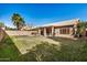 Backyard with a covered patio area, a hot tub, and a large grass area at 1569 E Princeton Ave, Gilbert, AZ 85234