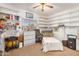 Bright bedroom with shelving around the room, a ceiling fan, and a window for natural lighting at 1569 E Princeton Ave, Gilbert, AZ 85234