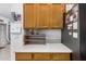 Kitchen detail showcasing light countertops, oak cabinets, and stainless steel refrigerator at 1569 E Princeton Ave, Gilbert, AZ 85234