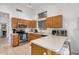 Bright eat-in kitchen featuring tiled floors, stainless steel appliances, and breakfast bar seating at 1569 E Princeton Ave, Gilbert, AZ 85234