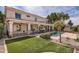 Inviting backyard with green lawn, pool, covered patio, and manicured landscaping at 1614 E Kathleen Rd, Phoenix, AZ 85022