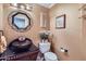 Stylish powder room with a unique bowl sink, decorative mirror, and elegant fixtures at 1614 E Kathleen Rd, Phoenix, AZ 85022