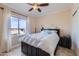 Bright bedroom featuring a ceiling fan and large windows for natural light at 1614 E Kathleen Rd, Phoenix, AZ 85022