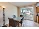 Bright dining area with glass table and a sliding door to the backyard at 1614 E Kathleen Rd, Phoenix, AZ 85022