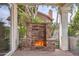 Inviting outdoor stone fireplace creates a warm focal point on the covered patio at 1614 E Kathleen Rd, Phoenix, AZ 85022