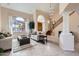 Bright living room with tall ceilings, large windows, and a cozy seating area at 1614 E Kathleen Rd, Phoenix, AZ 85022