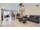Open-concept living area featuring tile floors, a kitchen with a bar, and comfortable seating at 1614 E Kathleen Rd, Phoenix, AZ 85022