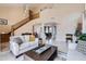 Spacious living room featuring high ceilings, elegant staircase, and comfortable seating arrangement at 1614 E Kathleen Rd, Phoenix, AZ 85022