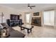 Comfortable living room with tile flooring, fireplace, ceiling fan, and dark wood furniture at 1614 E Kathleen Rd, Phoenix, AZ 85022
