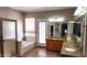Bright bathroom featuring a tub, walk-in shower, double doors and granite countertop vanity at 1614 E Kathleen Rd, Phoenix, AZ 85022