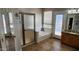 Bright bathroom featuring a tub, walk-in shower, double doors and granite countertop vanity at 1614 E Kathleen Rd, Phoenix, AZ 85022
