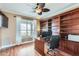 Home office with built-in bookshelves, wood floors, and a comfortable workspace at 1614 E Kathleen Rd, Phoenix, AZ 85022
