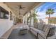 Relaxing covered patio featuring a cozy fireplace, comfortable seating, and serene ambiance at 1614 E Kathleen Rd, Phoenix, AZ 85022