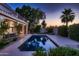 Inviting pool area with a sparkling pool, mature landscaping, and ample space for relaxation at dusk at 1614 E Kathleen Rd, Phoenix, AZ 85022