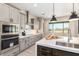 A gourmet kitchen boasts stainless steel appliances, stone countertops, and an island with a sink at 1620 E Cloud Rd, Phoenix, AZ 85086