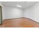 A spacious bedroom with wood laminate flooring, bright walls, and a skylight at 16827 N 103Rd Ave, Sun City, AZ 85351