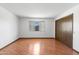 Bright bedroom with closet and large window with natural light and wood-look flooring at 16827 N 103Rd Ave, Sun City, AZ 85351