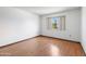 Clean bedroom with a large window, wood-look floors, and natural light at 16827 N 103Rd Ave, Sun City, AZ 85351