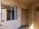 Covered porch and front door with security screen, window, and a hanging light fixture at 16827 N 103Rd Ave, Sun City, AZ 85351